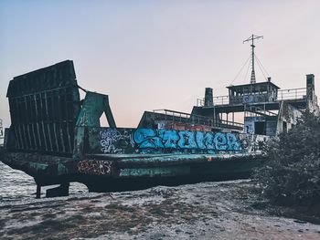 Old boat against clear sky during sunset