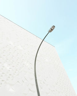 Low angle view of street light and building against sky