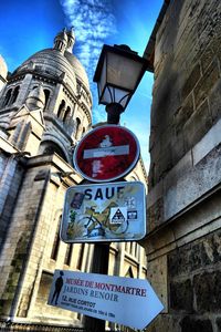 Low angle view of sign board against sky