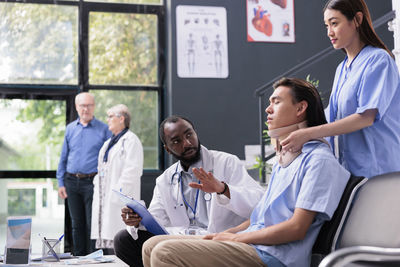 Female doctor examining patient in office