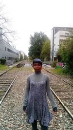 Woman standing on railroad track