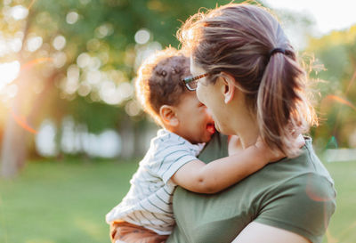 Side view of mother and daughter at park