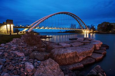 Pedestrian bridge over river against sky at early morning during dawn