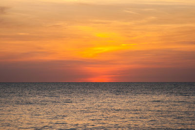 Scenic view of sea against orange sky