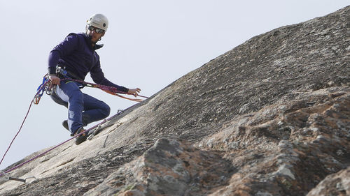 Low angle view of woman standing on mountain