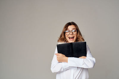 Portrait of beautiful young woman over white background