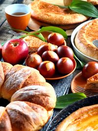 Easter food with eggs and homemade cakes on a wooden table.