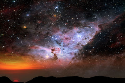 Scenic view of silhouette mountain against sky at night