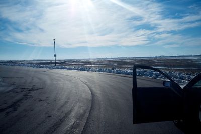 Open car on road against sky during winter