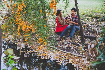 Couple with dog at riverbank