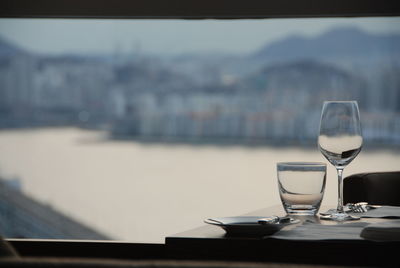 Glass of water on table against sky