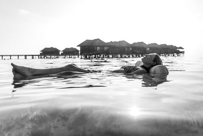 Full length of young man swimming in pool