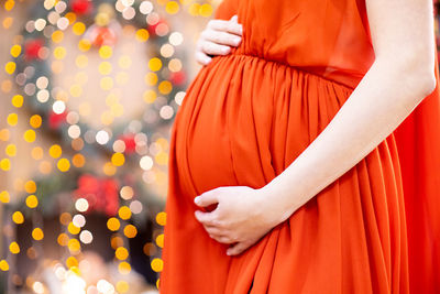 Midsection of woman standing outdoors