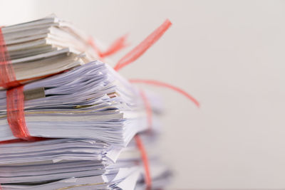 Close-up of stack of table against white background