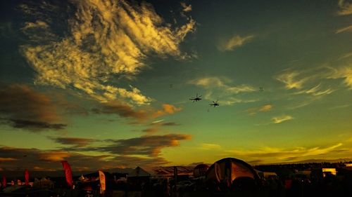 Silhouette of airplane flying in sky