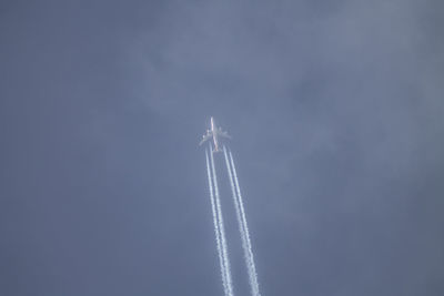 Low angle view of airplane flying in sky