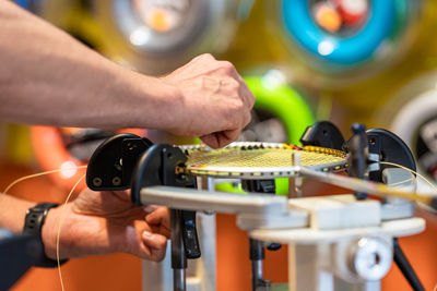 Cropped hand of man repairing car