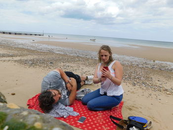 Young woman sitting on beach