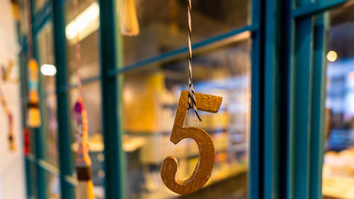 Close-up of decoration hanging on window