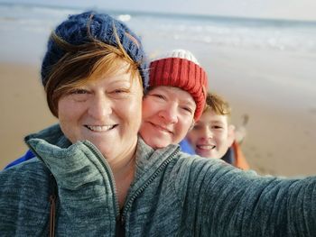 Portrait of happy family wearing warm clothing at beach