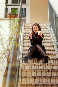 Portrait of a smiling woman sitting outdoors