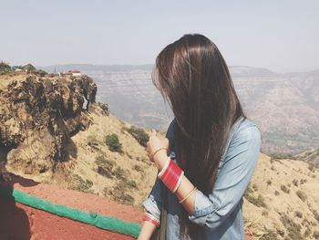 Woman standing against landscape