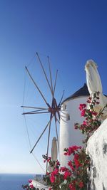 Low angle view of windmill against blue sky