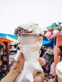 Close-up of hand holding ice cream