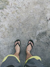 Low section of man standing on beach