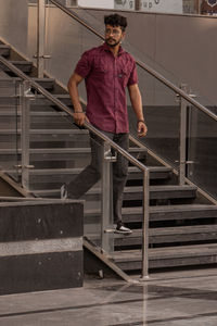 Low section of man standing on staircase