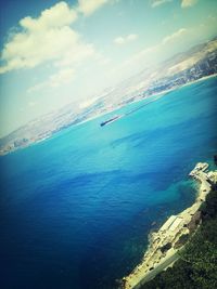 Scenic view of sea against cloudy sky