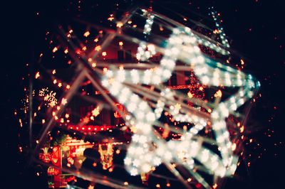 Defocused image of illuminated christmas lights at night