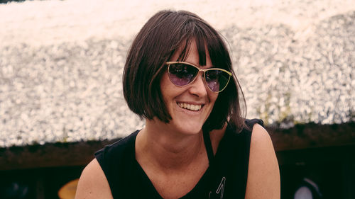 Portrait of smiling young woman wearing sunglasses