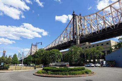 Bridge over road against sky in city