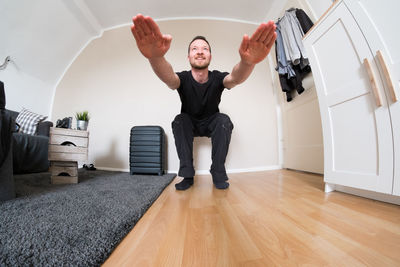 Fish-eye view of man exercising at home