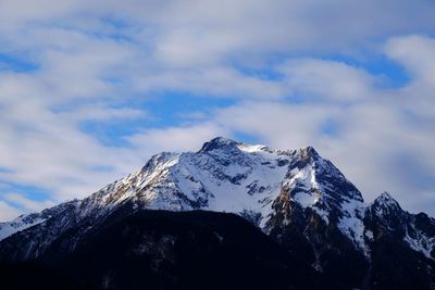 Low angle view of snowcapped mountain against sky