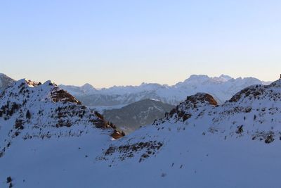 Scenic view of snowcapped mountains against clear sky