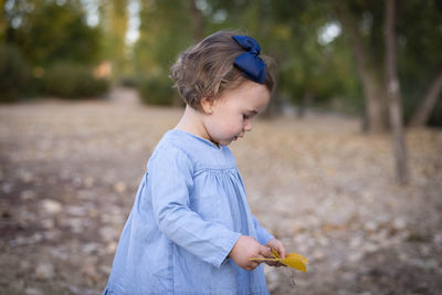 Side view of boy looking away on field