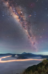 Milky way over mount bromo with light trail and sea of clouds