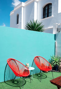 Summer armchair against a blue wall. home decor in detail. minimalist vacation concept