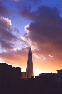 Low angle view of tower against cloudy sky