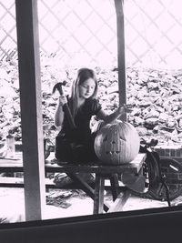 Portrait of woman sitting by window