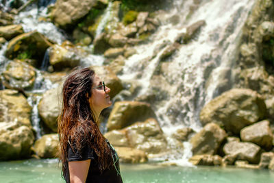 Woman looking at waterfall