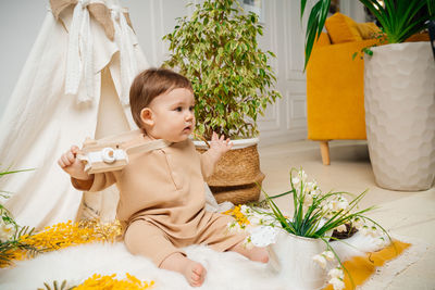 Portrait of cute girl playing with christmas tree