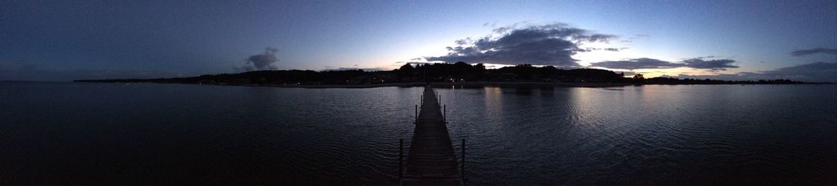 Scenic view of lake against sky at sunset