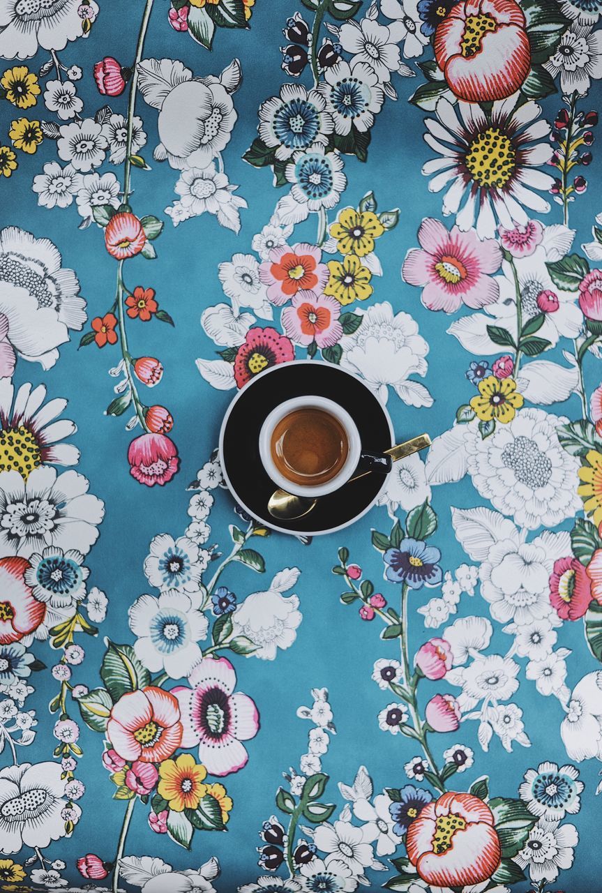 food and drink, drink, refreshment, directly above, pattern, floral pattern, flower, flowering plant, table, cup, mug, high angle view, saucer, crockery, coffee cup, coffee, coffee - drink, freshness, plant, tablecloth, no people, hot drink, glass, non-alcoholic beverage, tea cup, bouquet