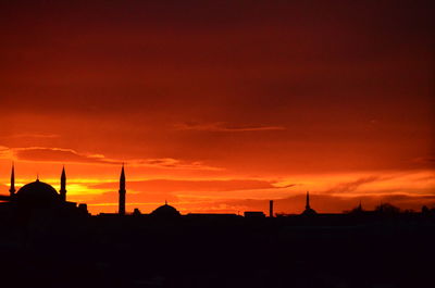 Silhouette of built structure against dramatic sky