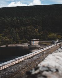 Railroad tracks by land against sky