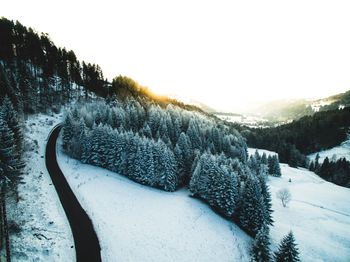 Snow covered landscape against clear sky