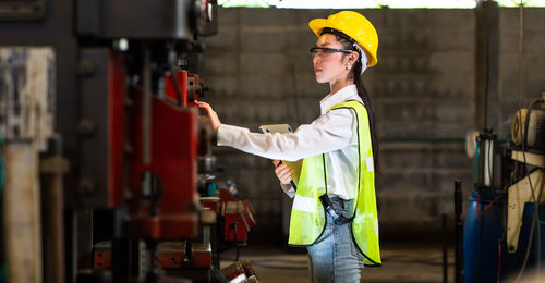 Side view of man working at construction site